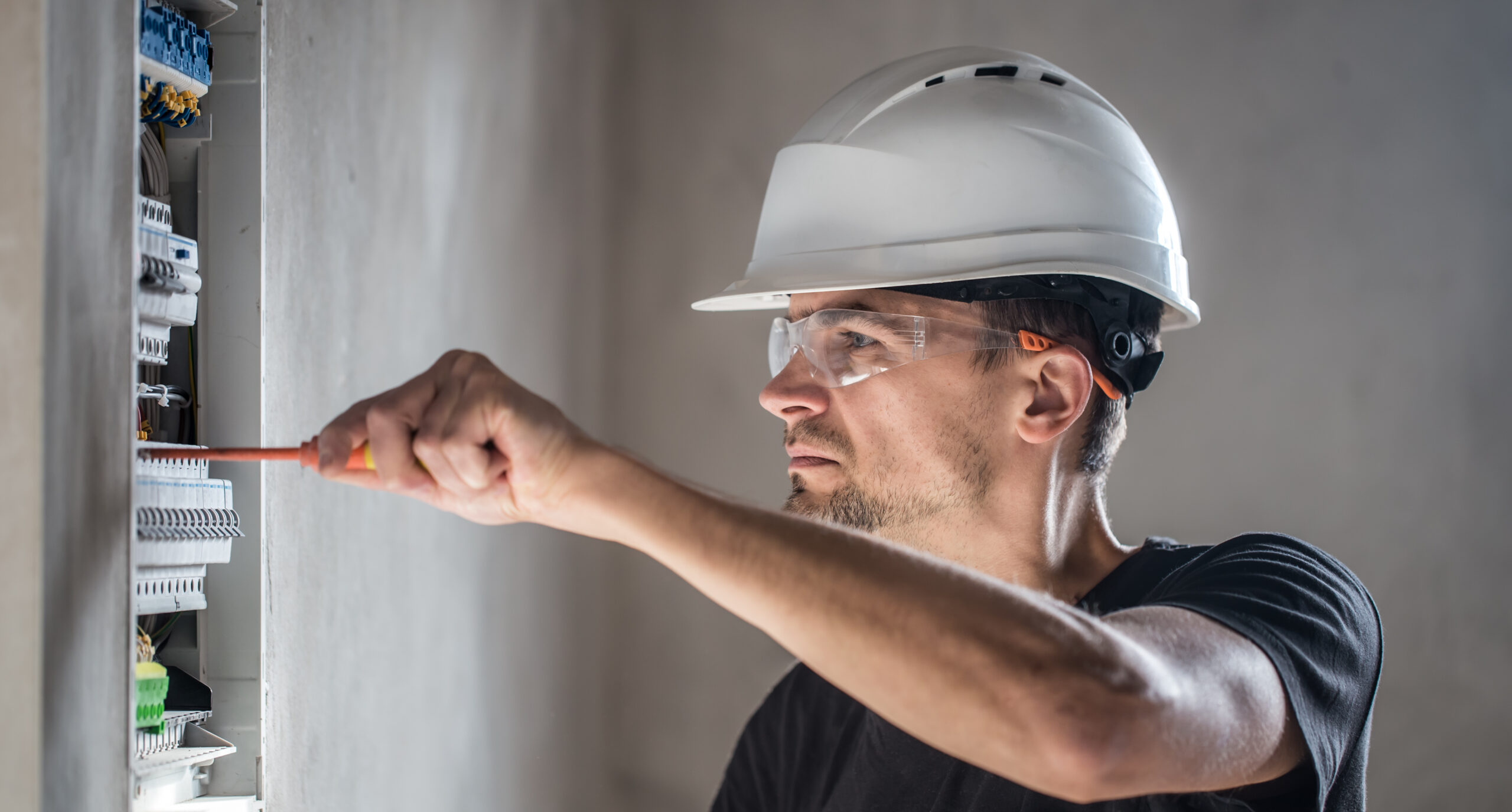 Electrician inspecting a home’s electrical panel.