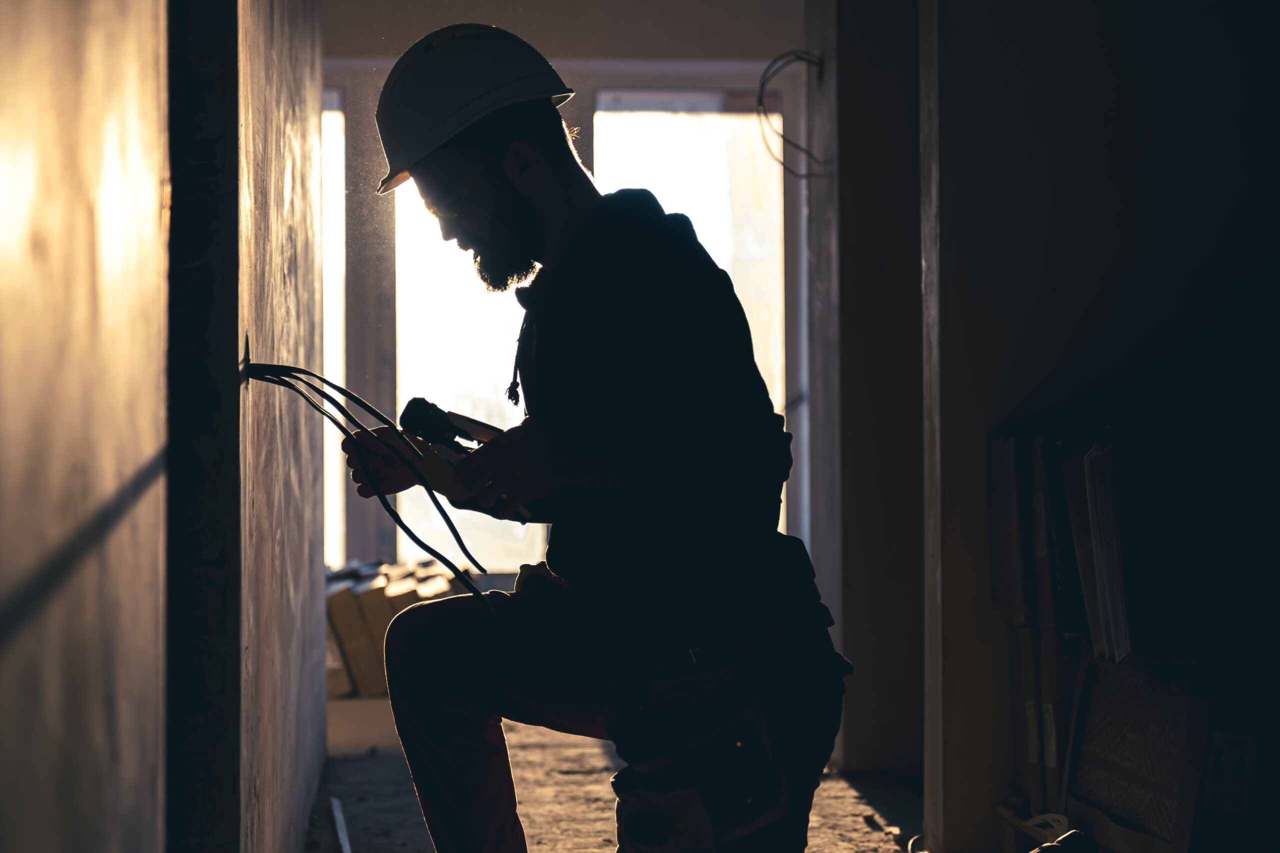 Electrician inspecting a home's electrical panel.