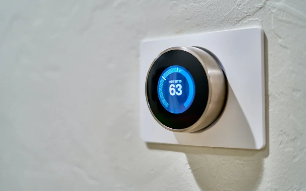 Smart thermostat displaying energy-saving settings in a modern home.