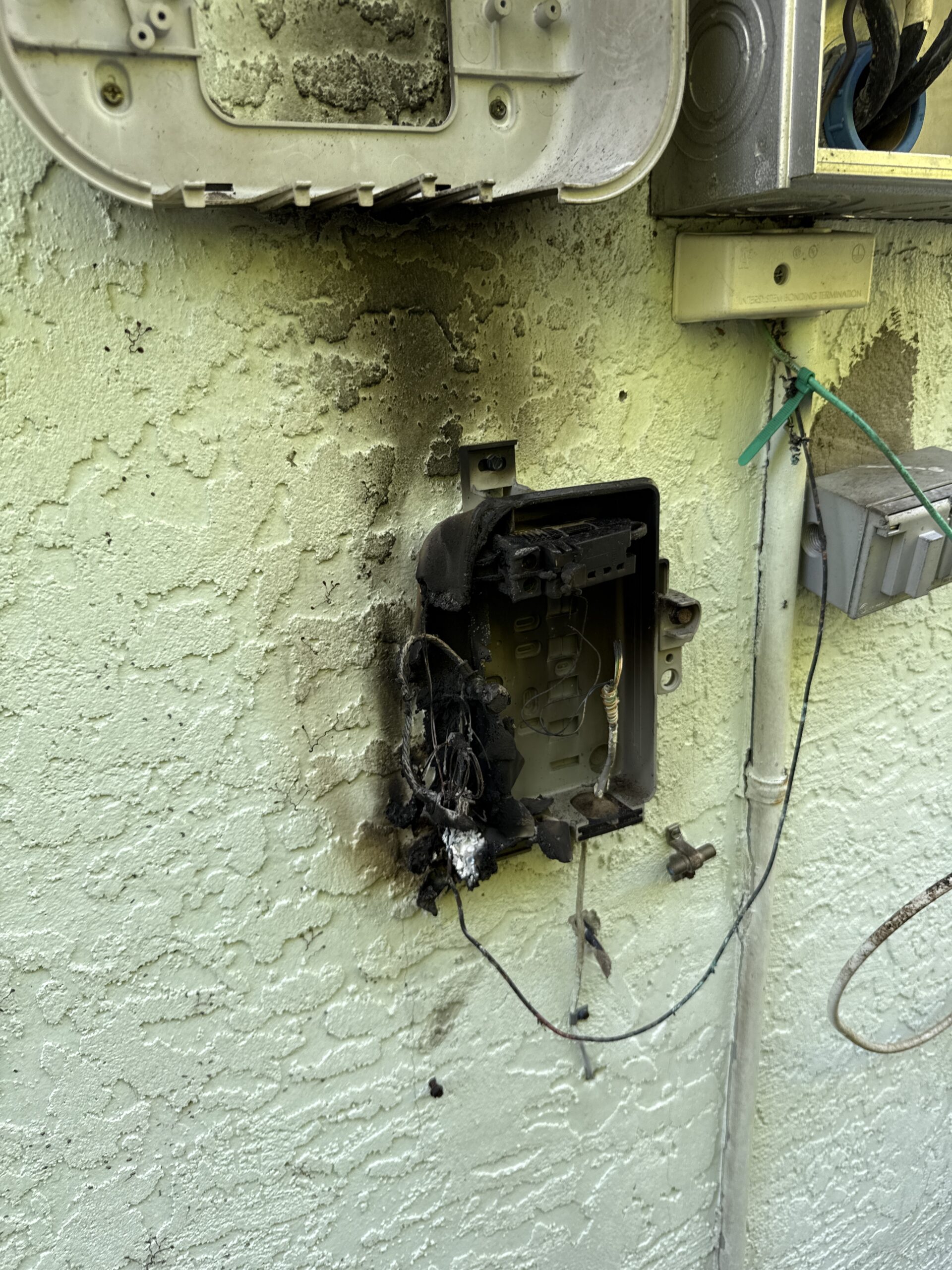 Licensed electrician performing breaker panel repair in residential home